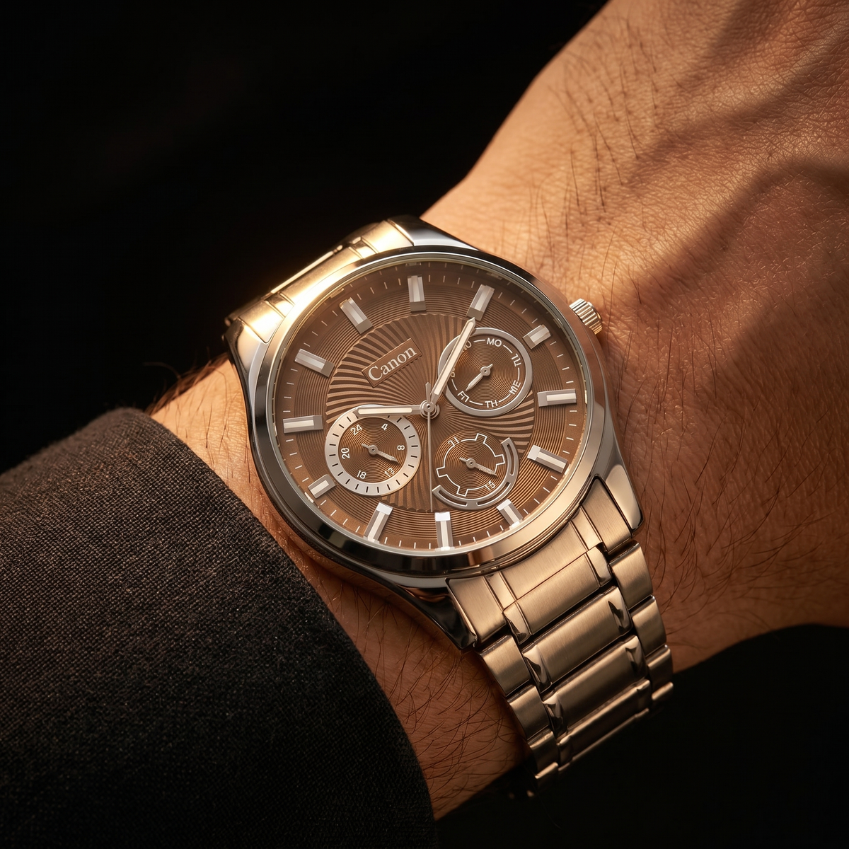 Canon men's analog quartz watch with brown dial, day-date subdials, and stainless steel strap on wrist
