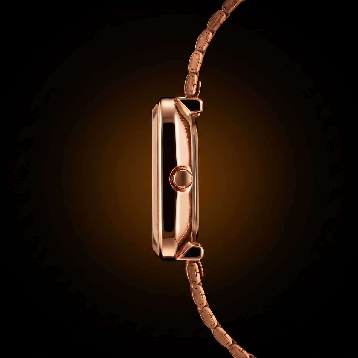 Rose gold analog quartz watch with sleek metal bracelet, side profile view