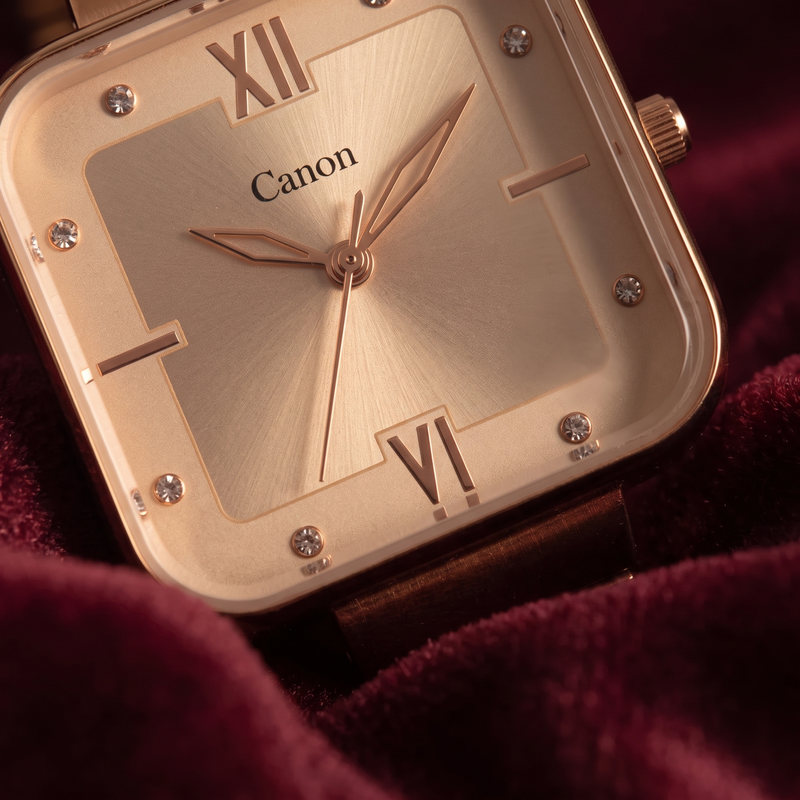 Elegant rose gold analog watch with Roman numerals, crystal accents, and Canon branding on dial