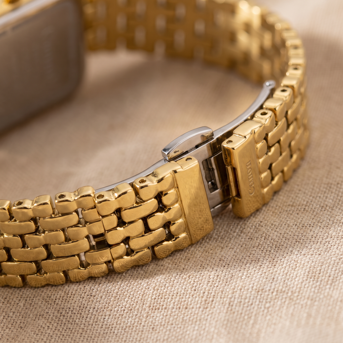 Macro of CN-532 five-row gold stainless steel bracelet and butterfly clasp
