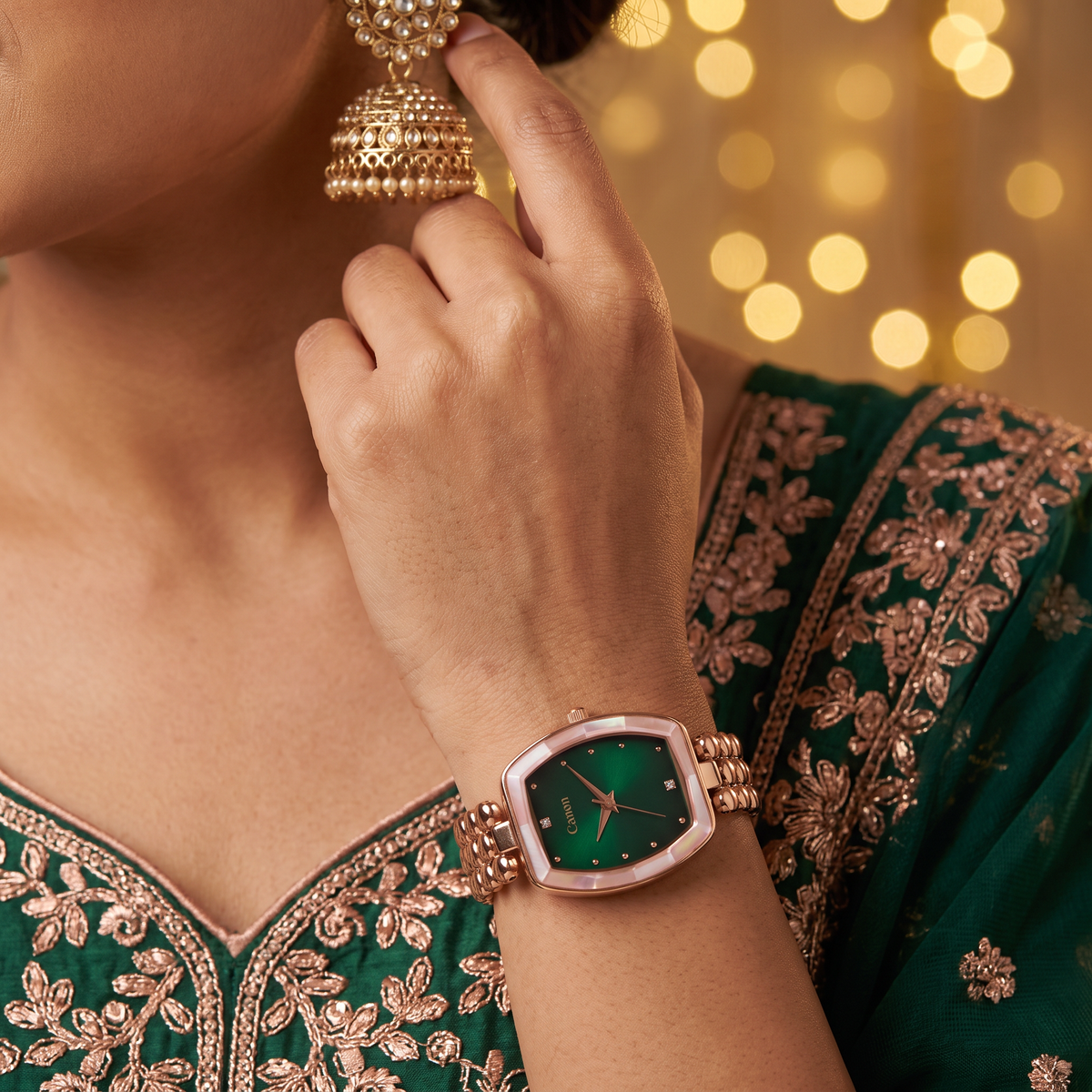 Woman in emerald lehenga wearing CN-525 emerald green rose gold watch
